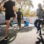 man in black t-shirt and black shorts running on road during daytime